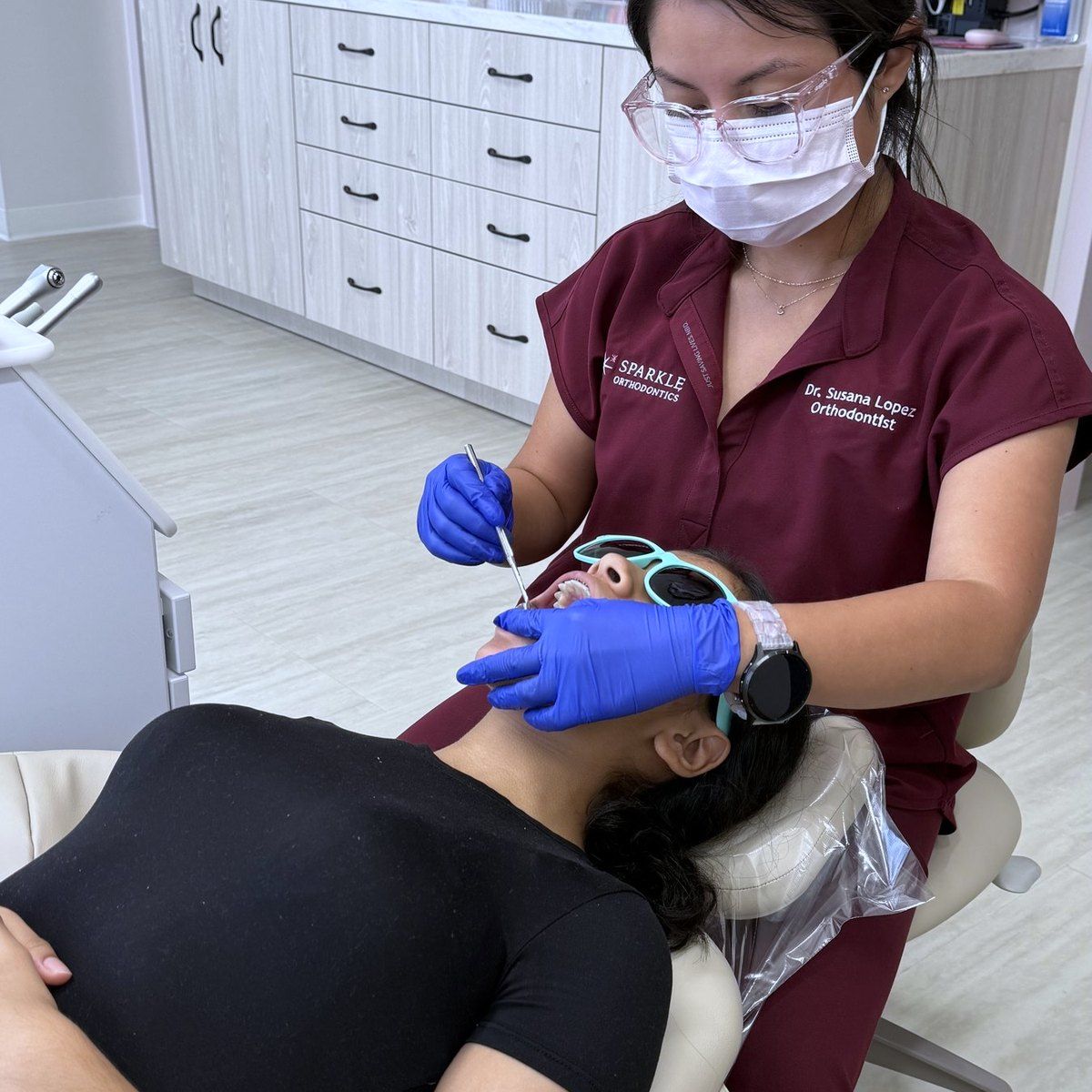 Dr. Lopez treating a patient at Sparkle Orthodontics